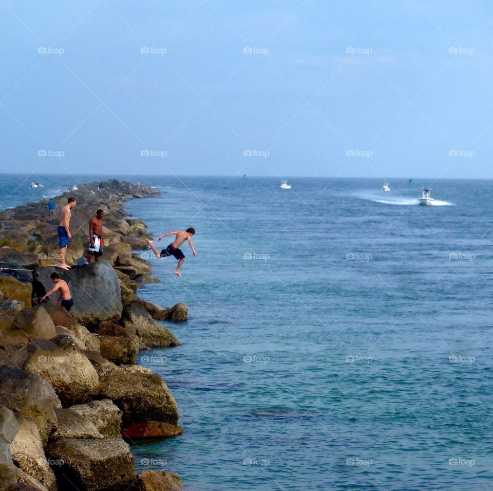 Jumping off the rocks, east coast, Florida 