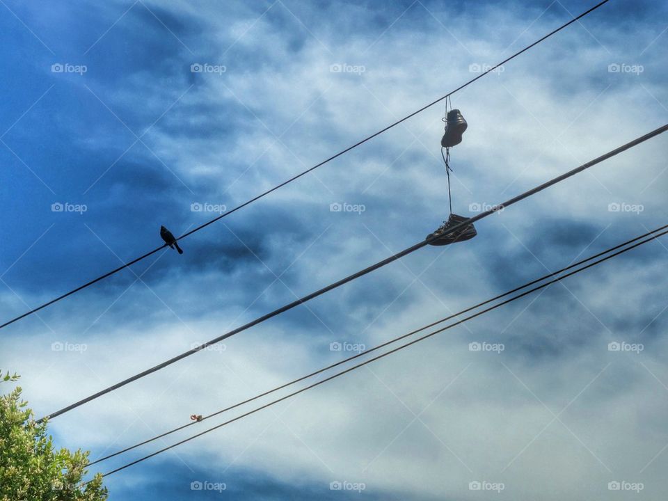 Shoes hanging from a wire 