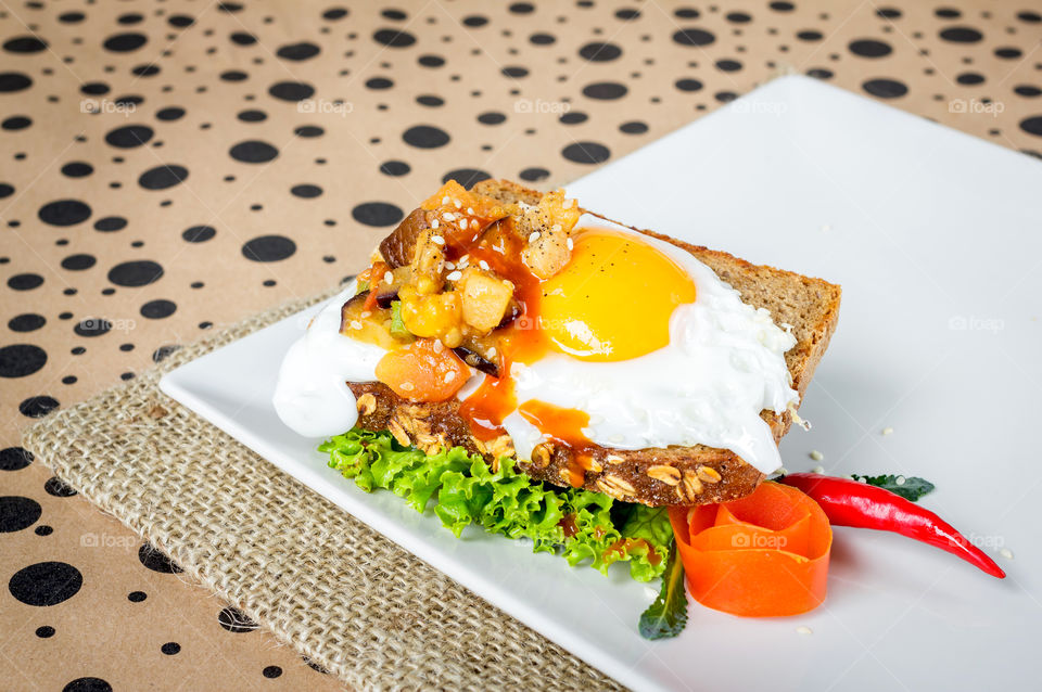 Spicy stuffed egg on top of toast, healthy breakfast 