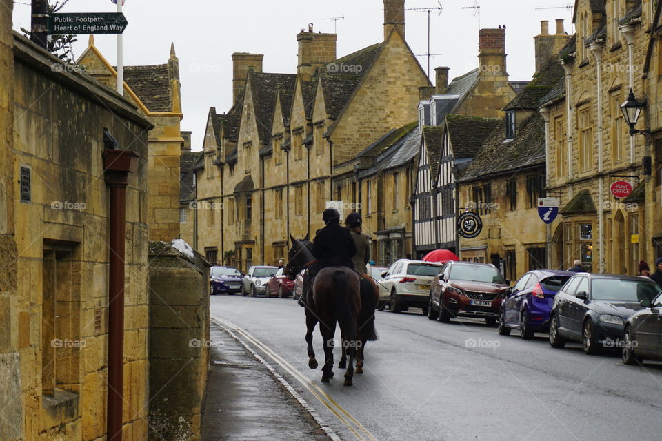 Riding through a Cotswold Village on a horse 