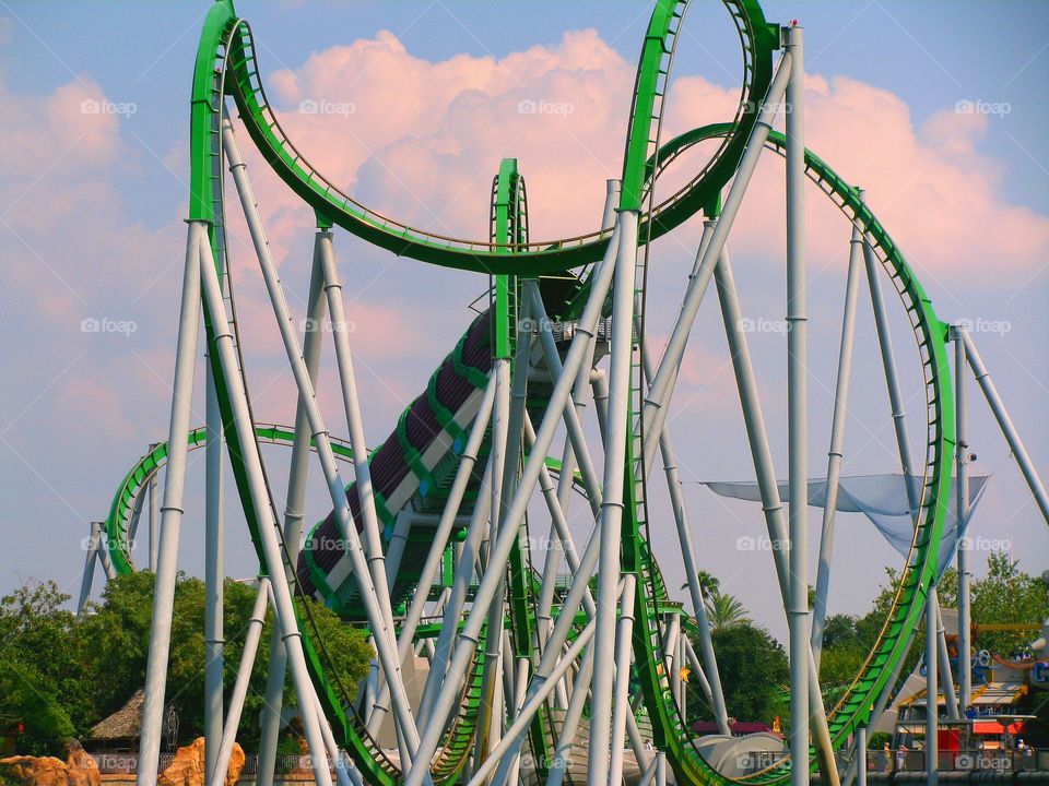 The Incredible Hulk Coaster begins its ascent into the early evening in Orlando, Florida backdrop. Ultra fast 67MPH mean green looping fury! Universal Studios. One fantastic rollercoaster in a family friendly top tier theme park.