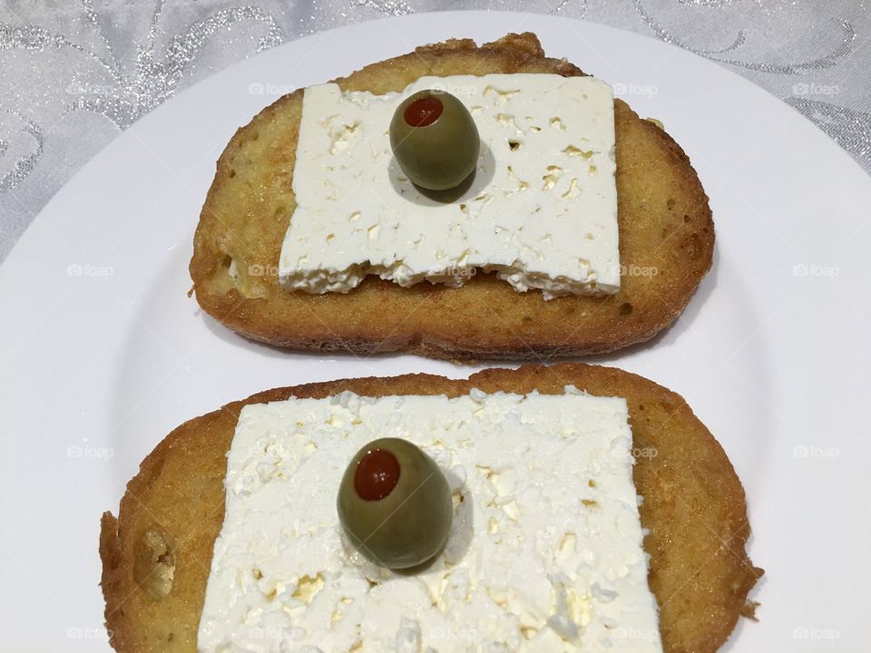 French toast with feta cheese and pickled  olives
