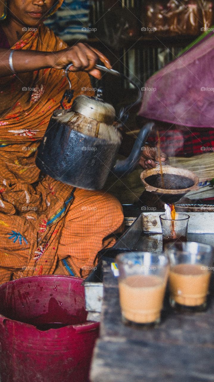 A native woman in Bangladesh working in a small tea stall. 