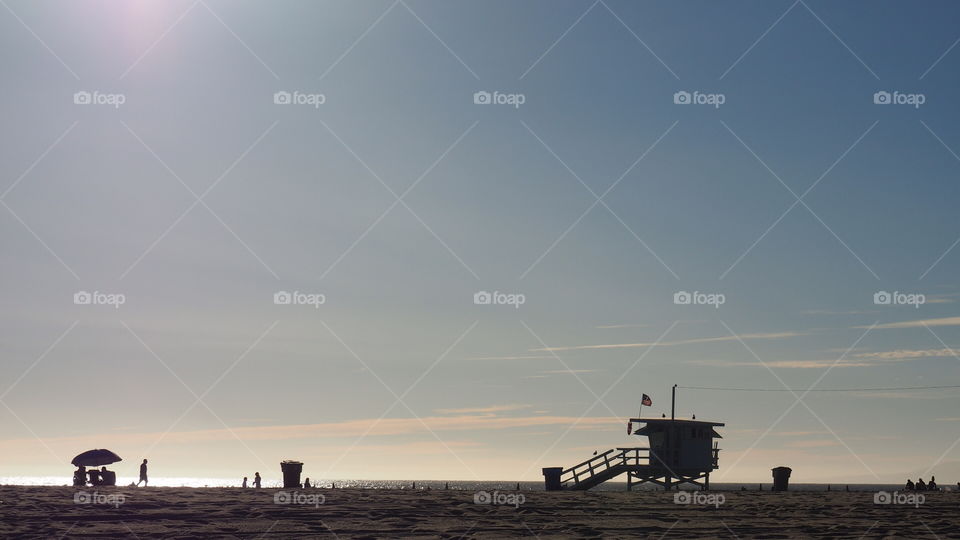 Beach landscape sunset scene. Sunset backlight postcard lifesaver lifeguard santa monica california beach sand