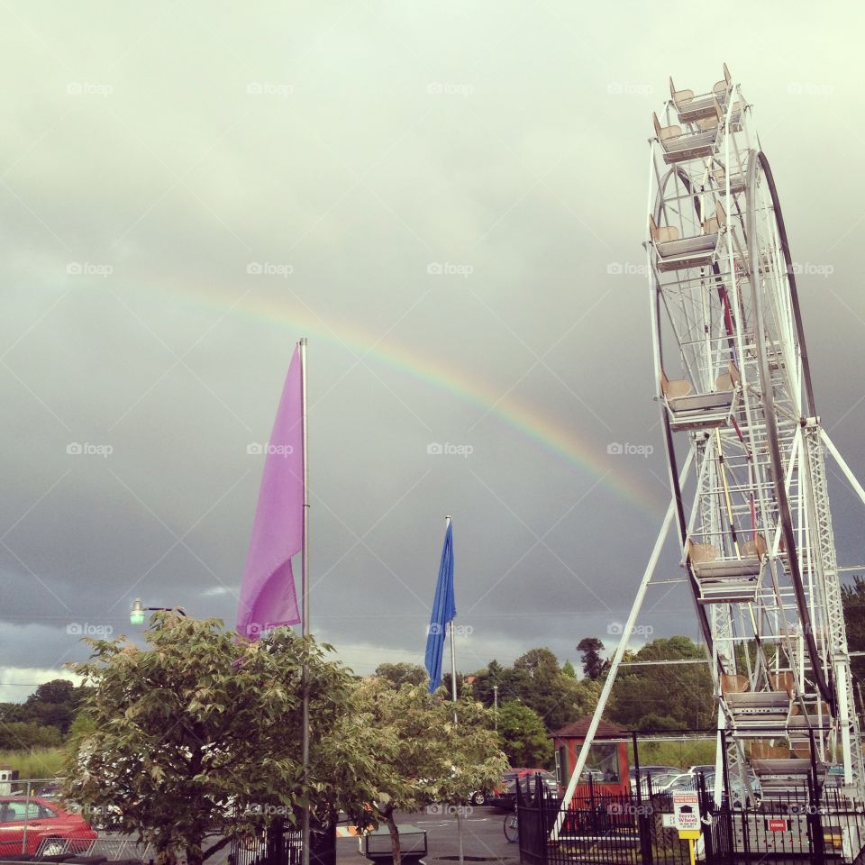 Beautiful Ferris wheel and rainbow