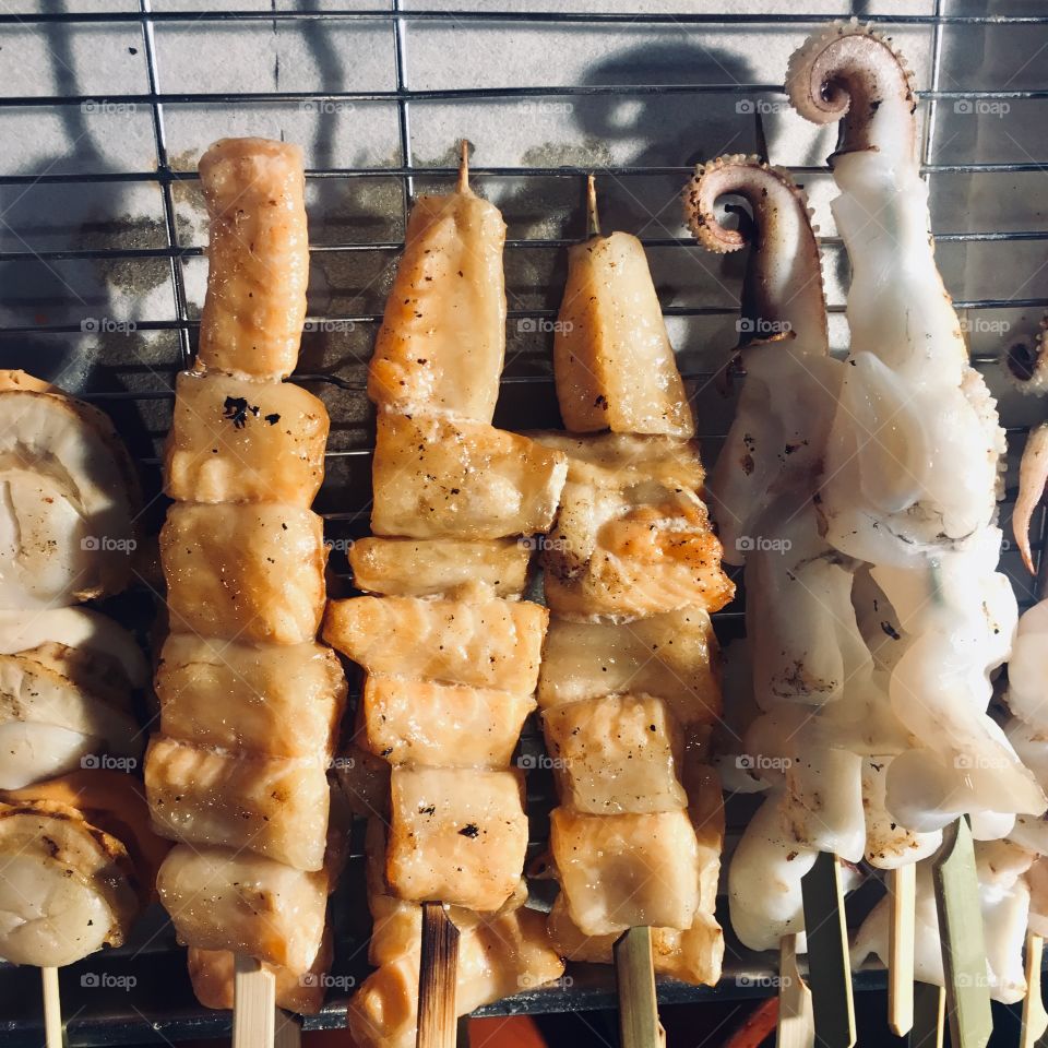 Salmon belly and squid skewers that you can buy near the famous Glico in Japan. 