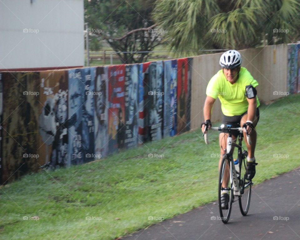 Biking with artwork behind