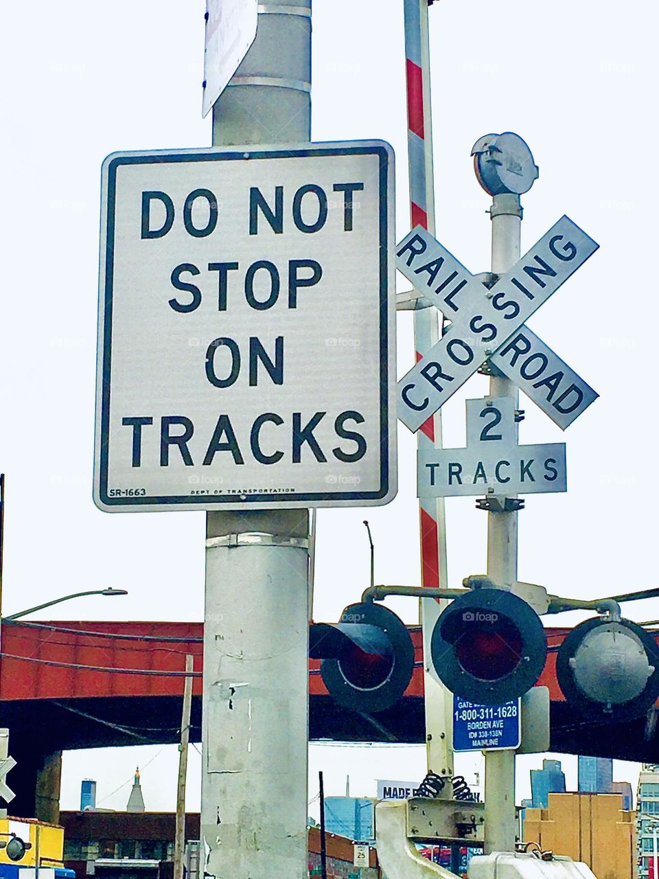 „DO NOT STOP ON TRACKS“ it says in big bold black letters and again „RAILROAD CROSSING“ just in case the barrier in the down position or the upcoming train has gone overlooked here by the „Pulaski Bridge“ at „11th St“. 2018. Hypnotic Productions