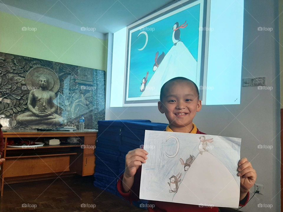 A little monk showing his art