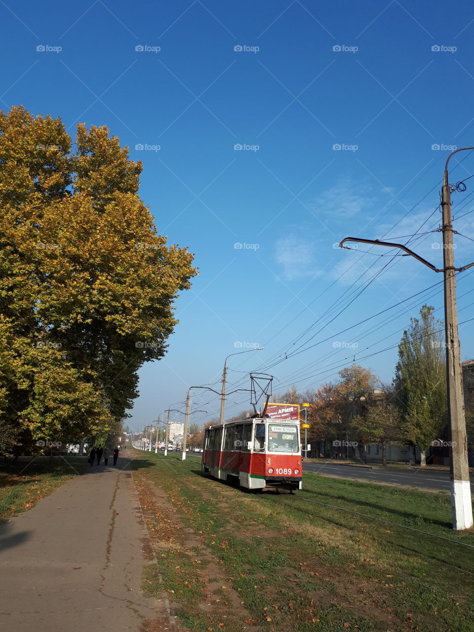 Red tramway go down the street