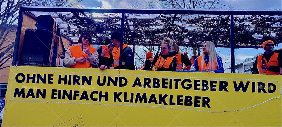„Without a brain or an employer turn climate activist gluing stuff to the foyer.“ Roughly translated this is the inscription of a float in the carnival parade in „Bad Füssing“, „Bavaria“ on „Mardi Gras“ or „Fat Tuesday“. 2024. Hypnotic Productions