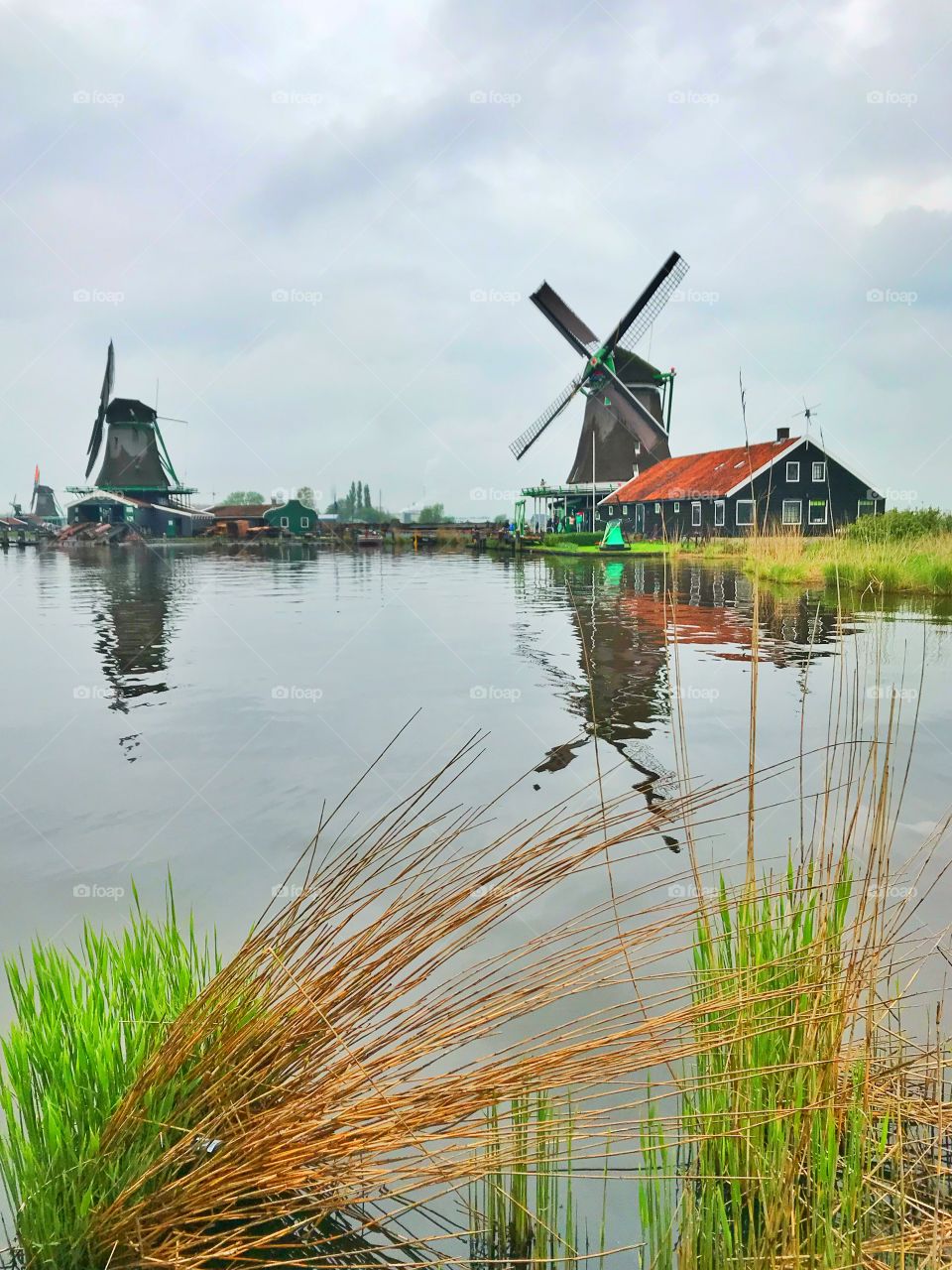 Windmills and water canal in Zaans Schans , Netherlands 