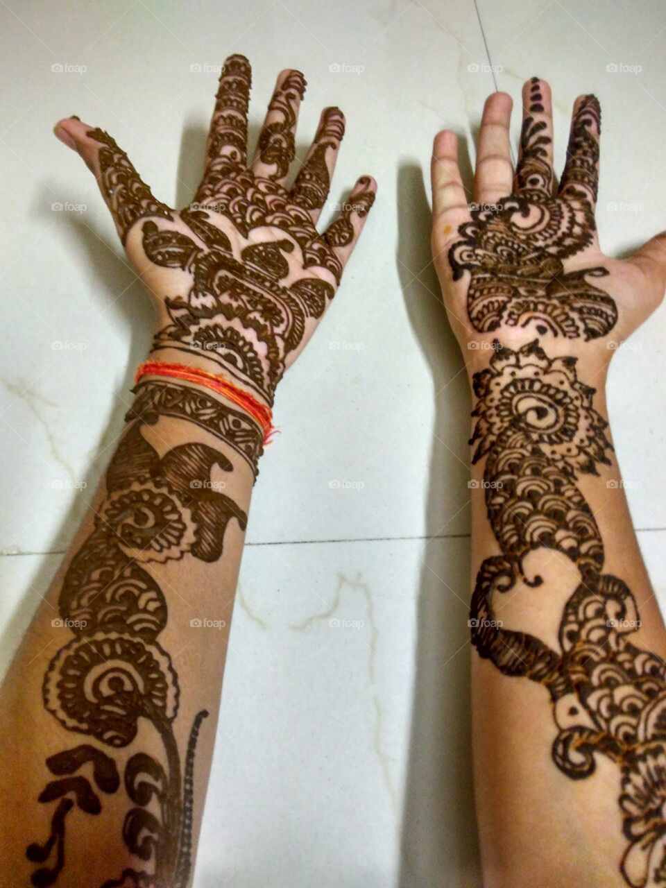 Hands with mehndi design on it