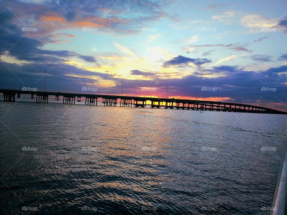 Enjoying a beautiful summer evening watching the sunset over the harbor bridge off the Gulf Coast of Florida.