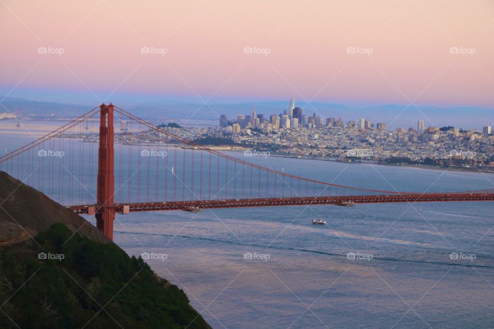 Bridge over the ocean and city view on dusk 