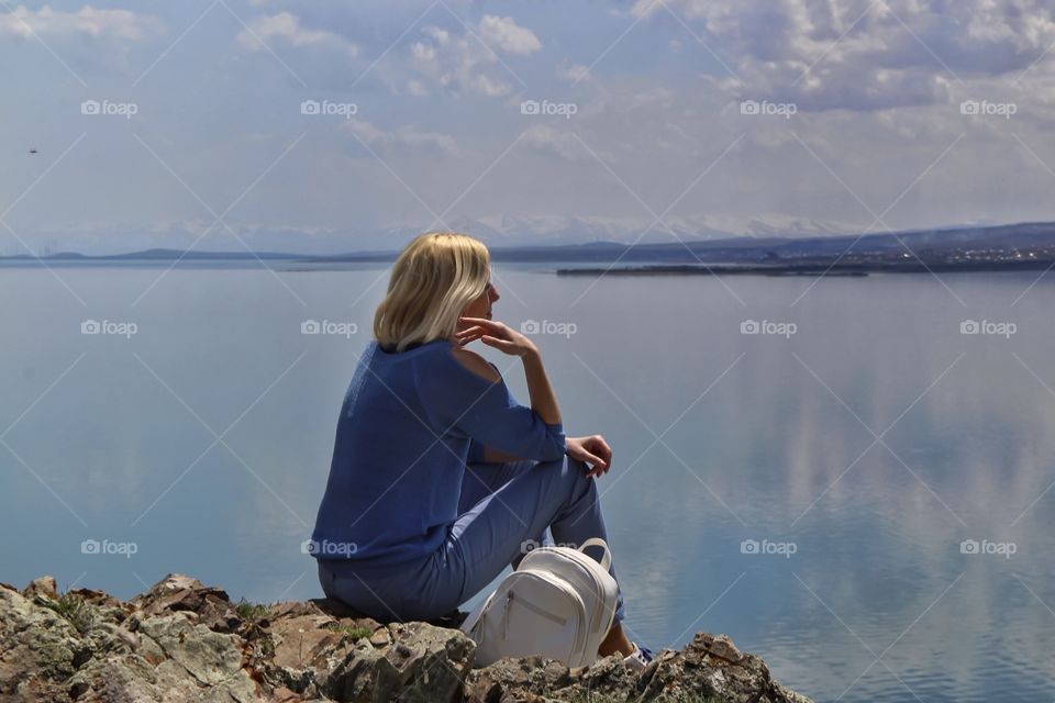 Woman sitting on the lake