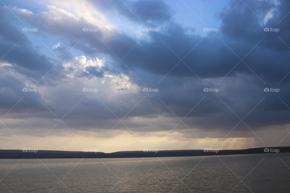 Dark clouds and back water, sunset,