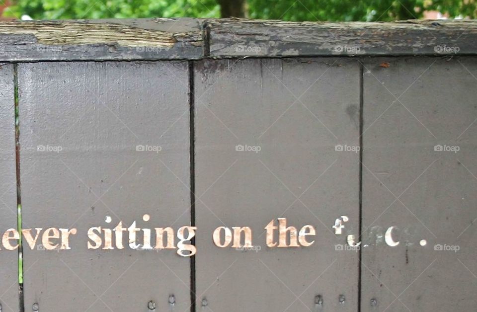 Sitting on the fence . Found text on  a garden fence in Nottingham city centre, thought it was thought provoking 