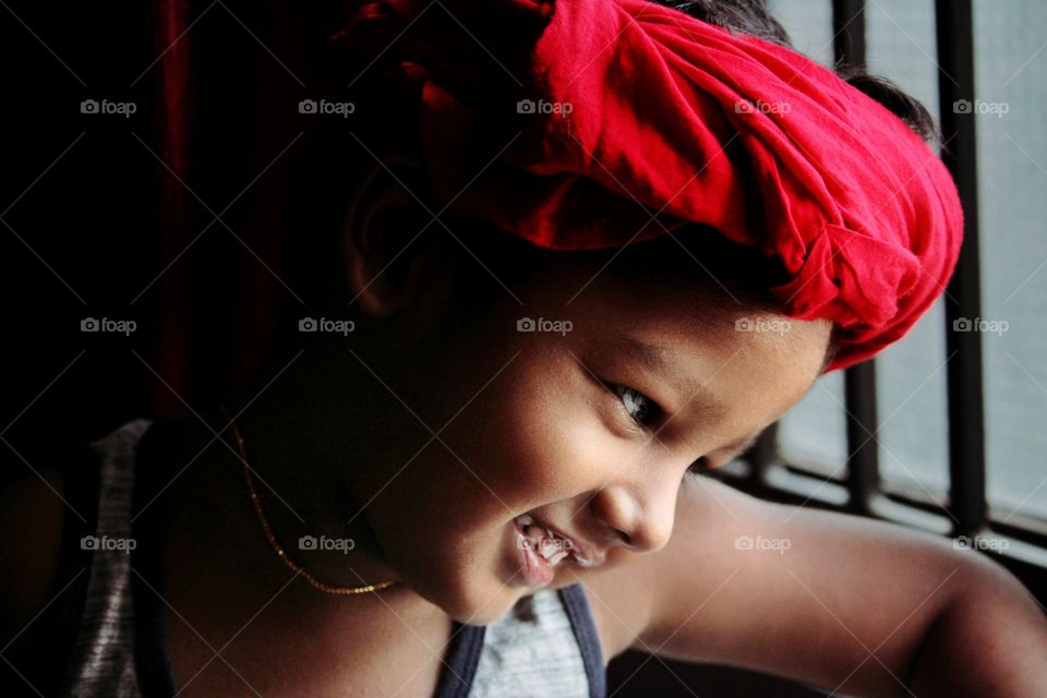 innocent smile of a little baby boy in red turban