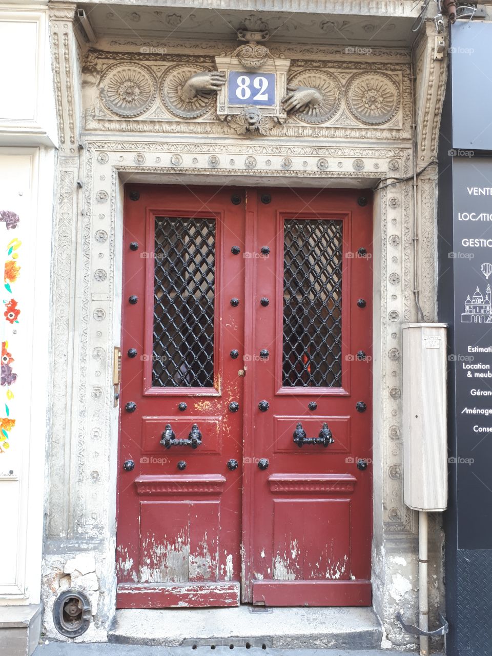 Wooden red entrance door with metal grate