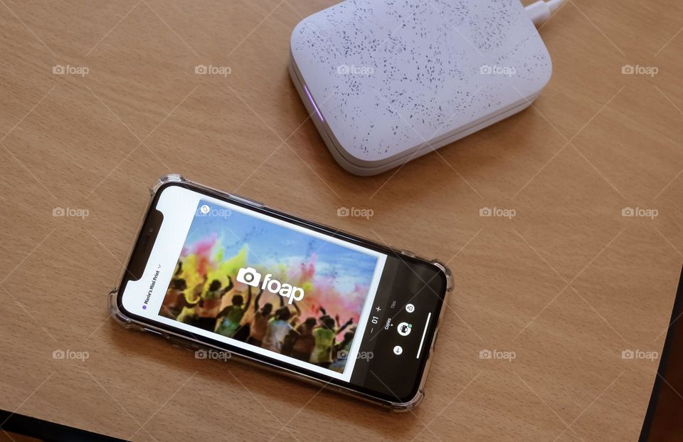 iPhone XS and mini printer on a desk