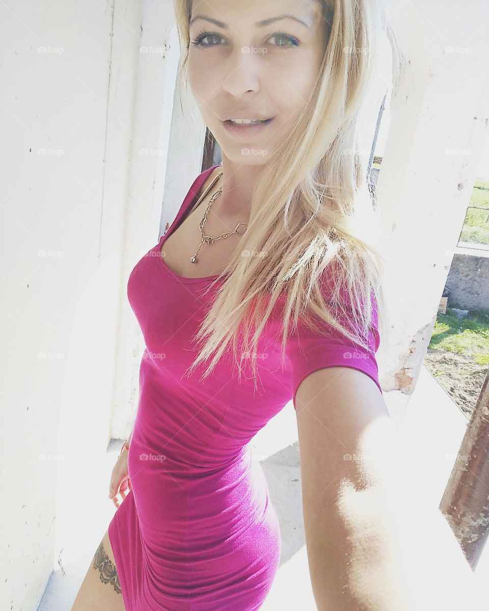 Woman in pink dress taking selfie