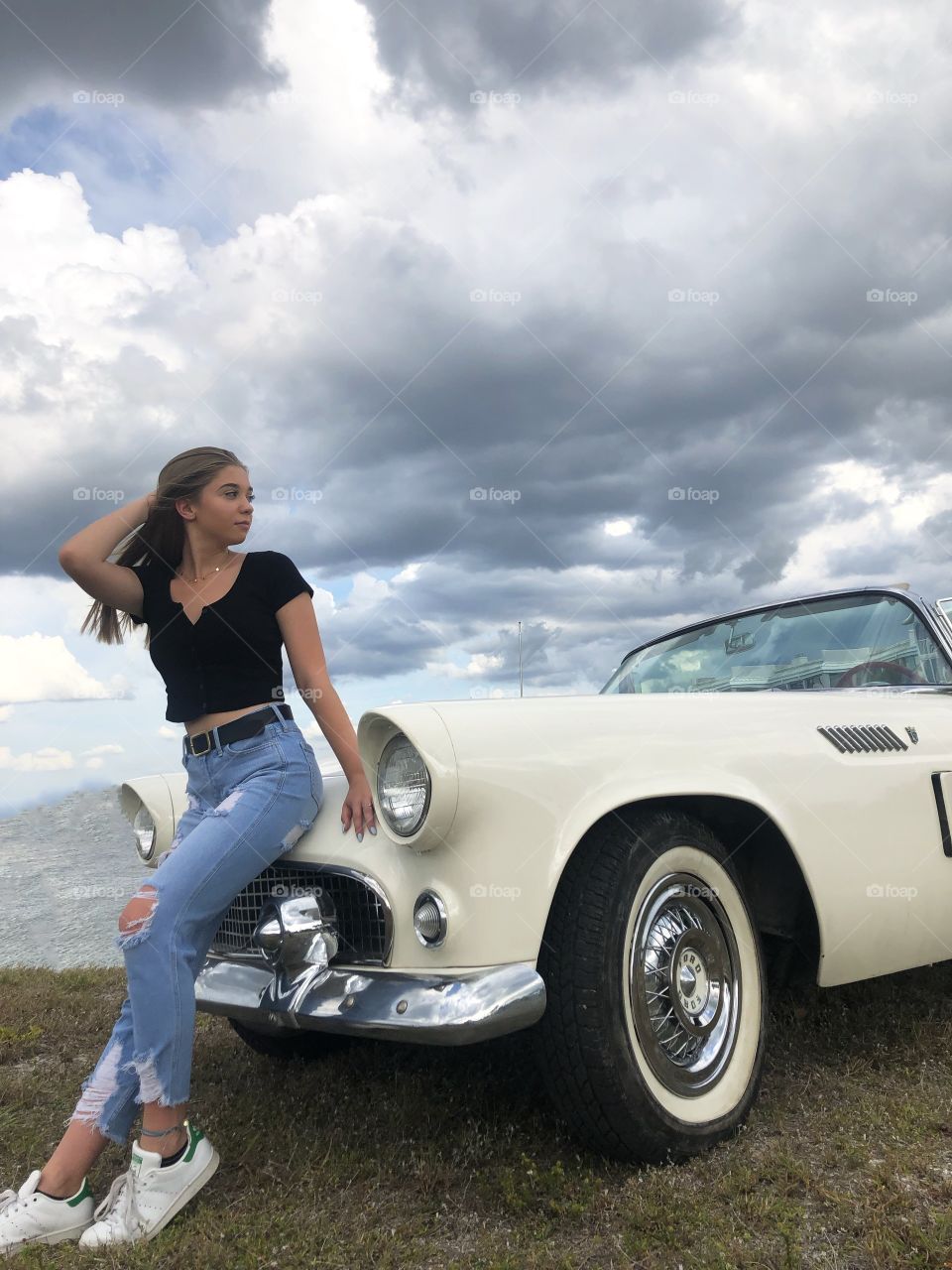 Young woman and a 1957 Thunderbird