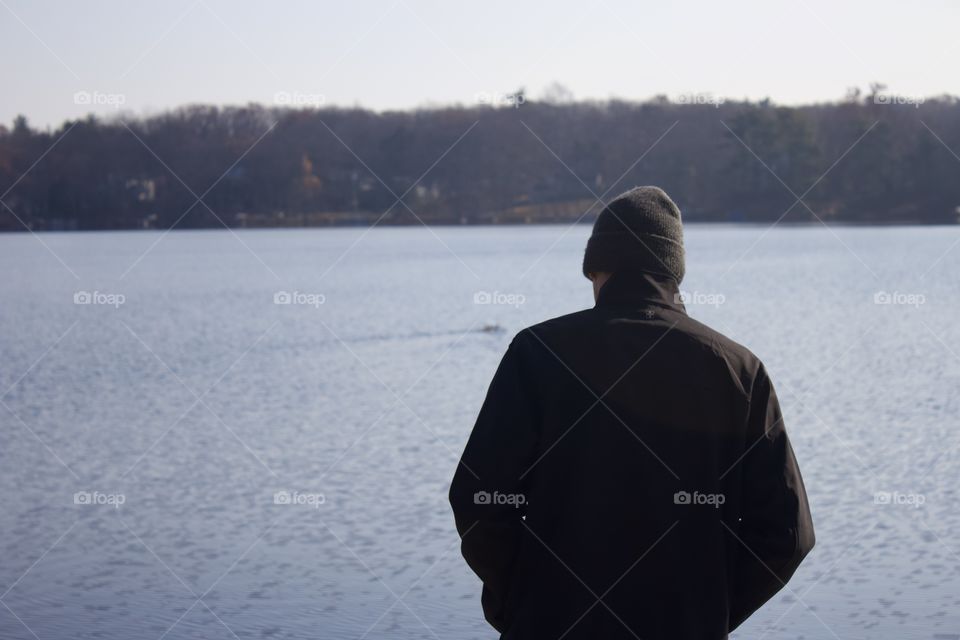 By the lake; Man standing in front of a glacial lake in Milford, Pennsylvania USA