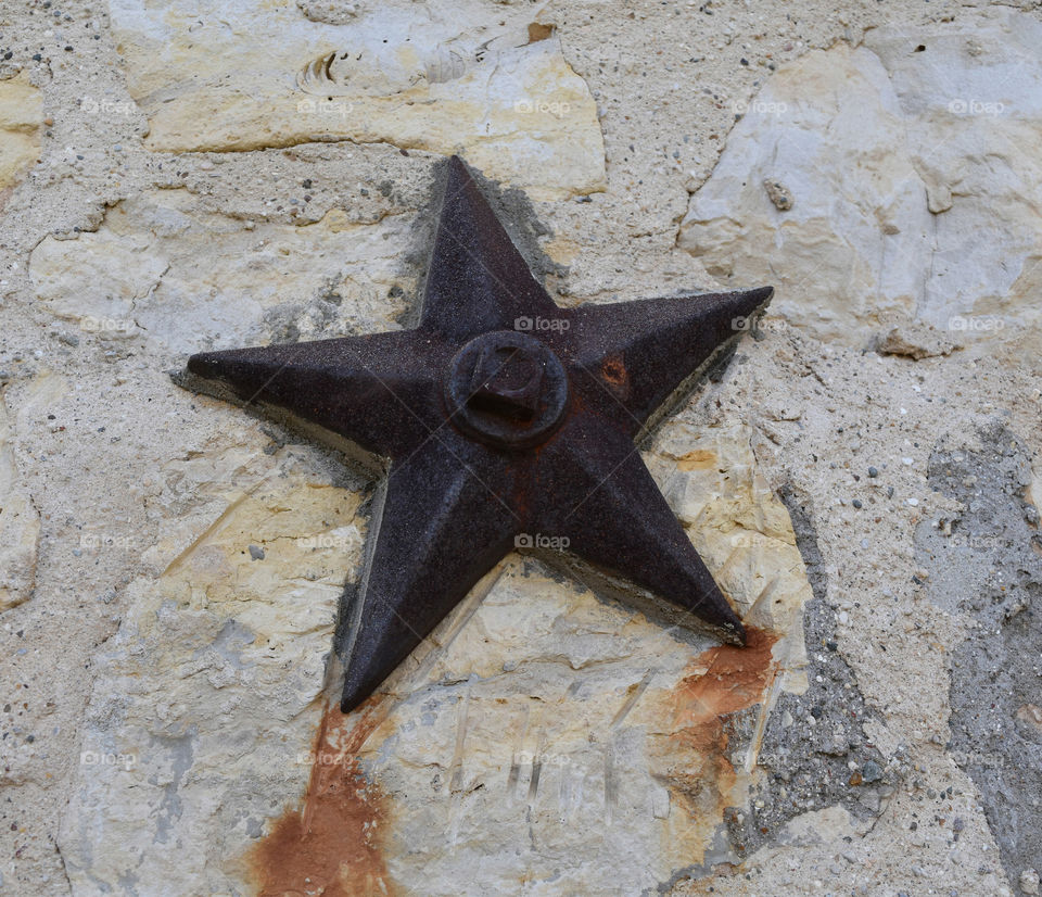 Metal star on a stone wall