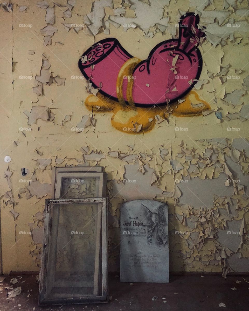 Tombstone and sausage graffiti in an abandoned hotel in Austria 
