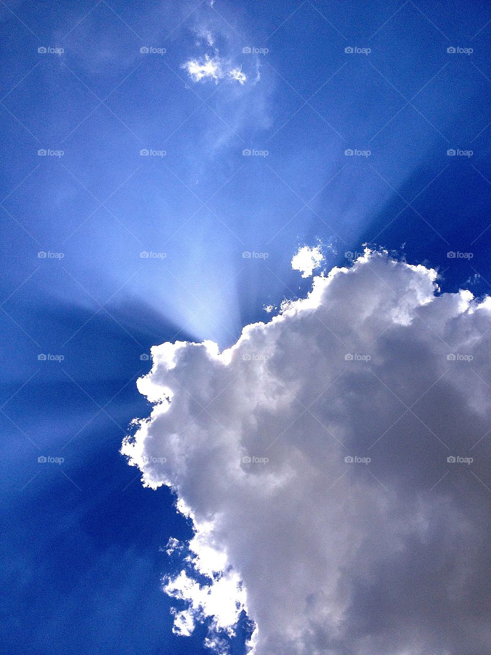 Cloud sun beam. Sun beam behind cloud