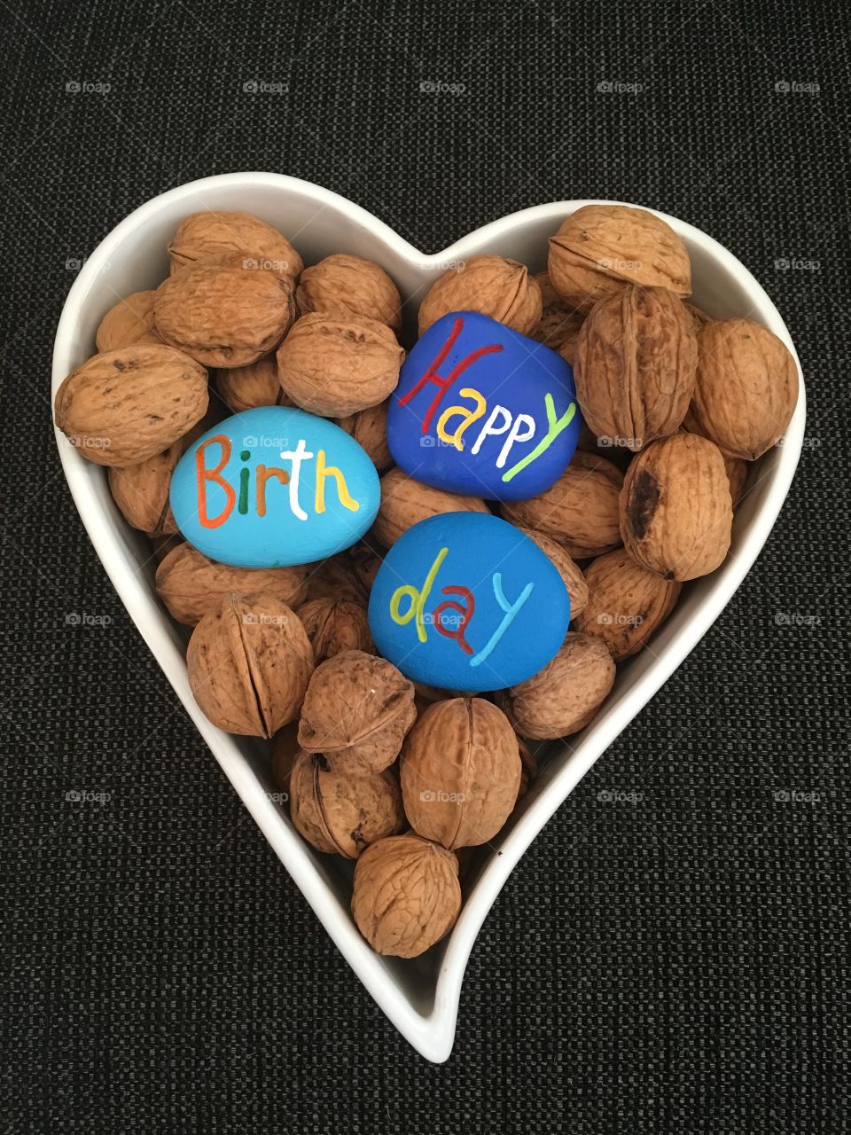 Happy Birthday message with stones on walnuts 
