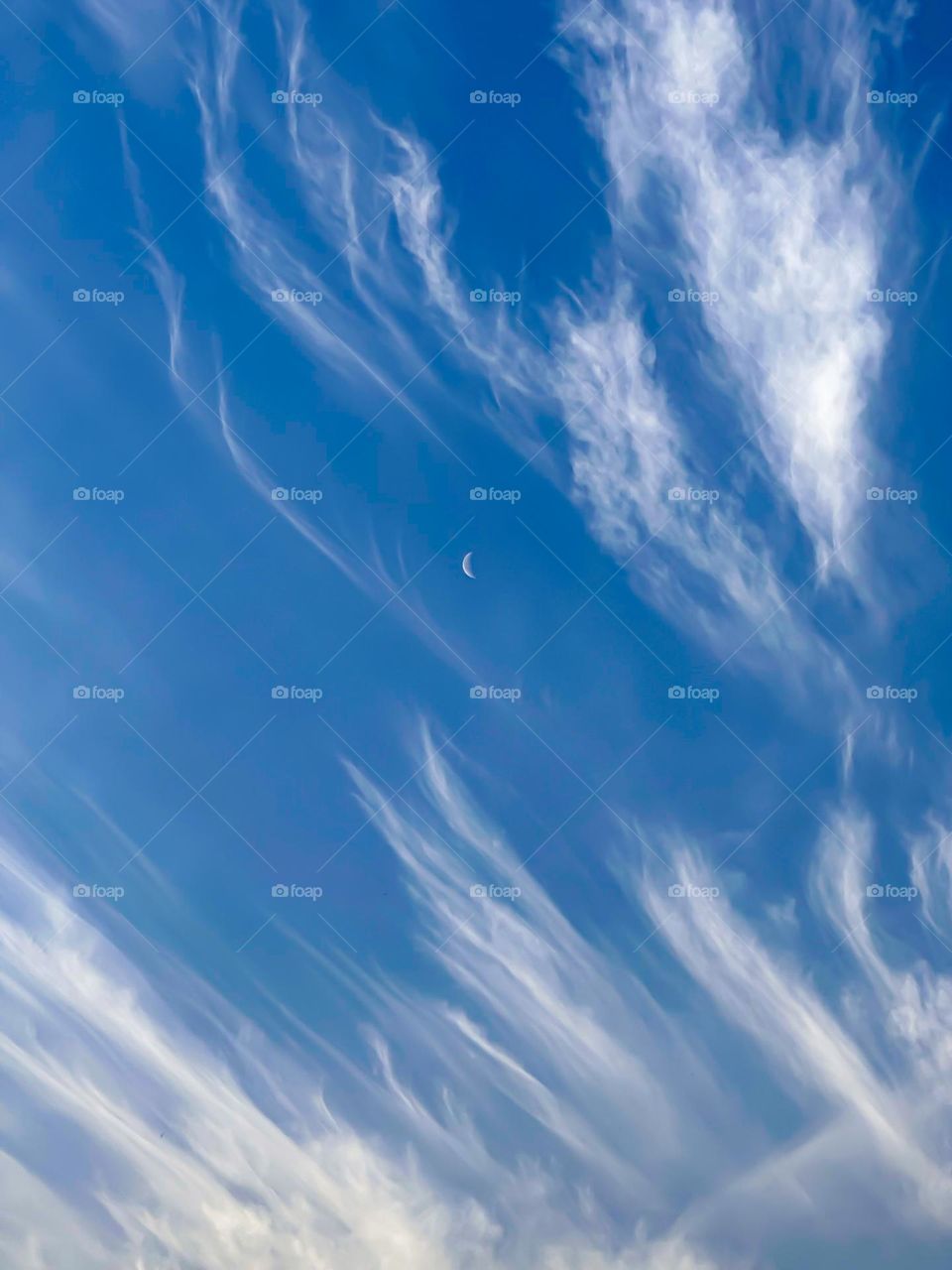 Sky with silver linings of clouds and moon in middle 