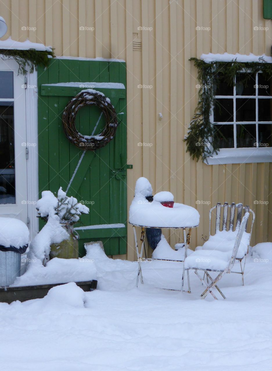 Garden furniture covered with snow