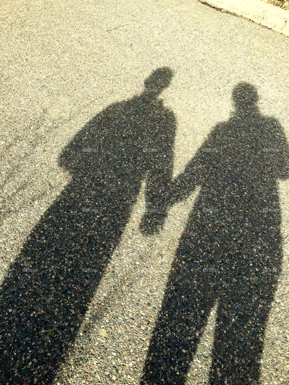Shadow lovers holding hands.