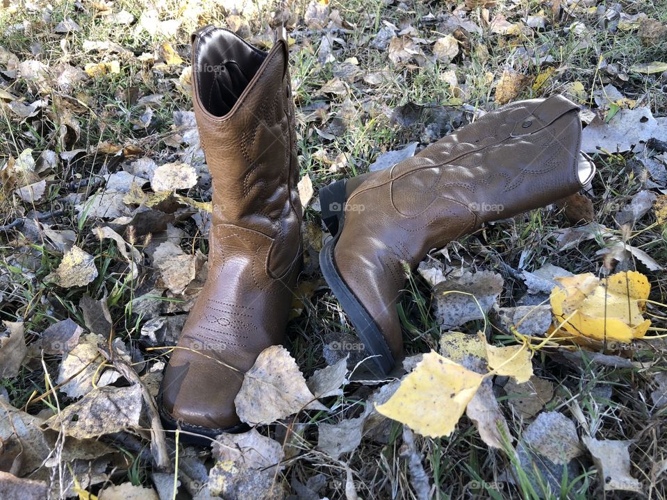 A fall day and a little boys cowboy boots forgotten outside
