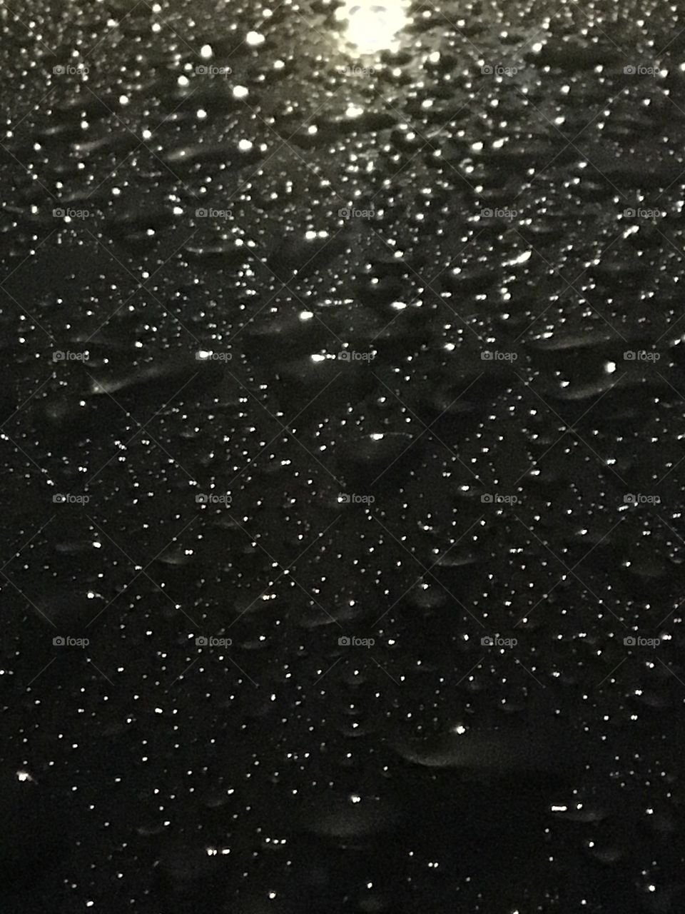 Night water beading on the car after the rain