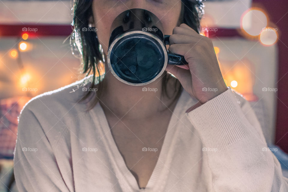 Young girl drinking a cup of coffee