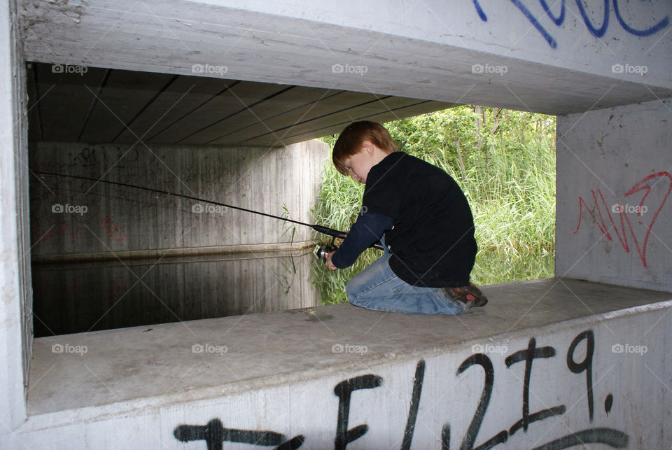 concentrated fishing. boy. bridge. grey. adhd.  quite time farum. denmark by snutten