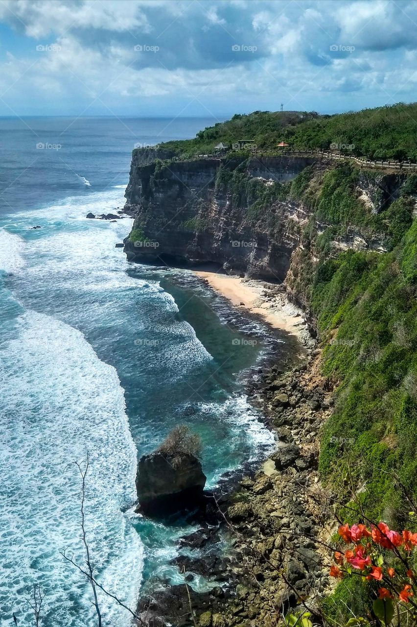 High cliffs border the ocean in high angle view