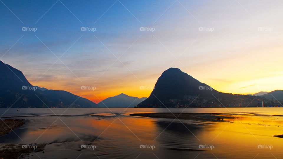 Golden dusk over the lake of Lugano