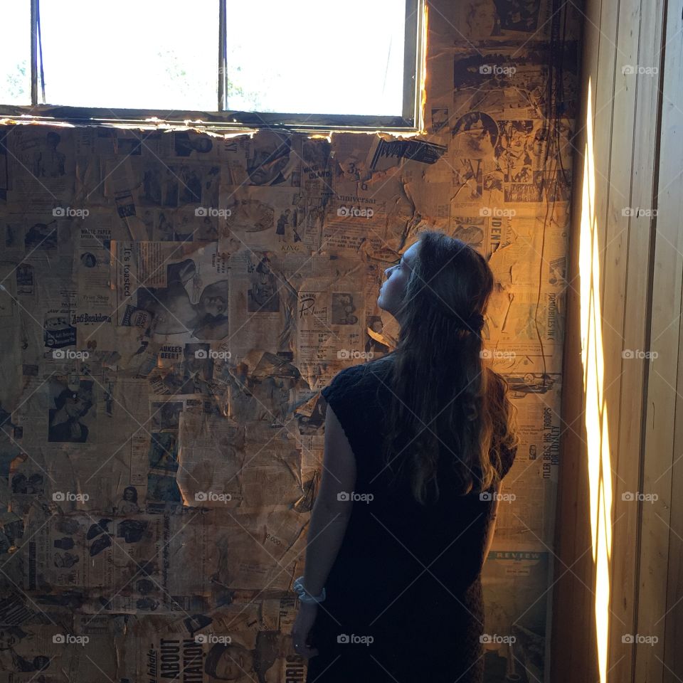 Rear view of woman standing in room