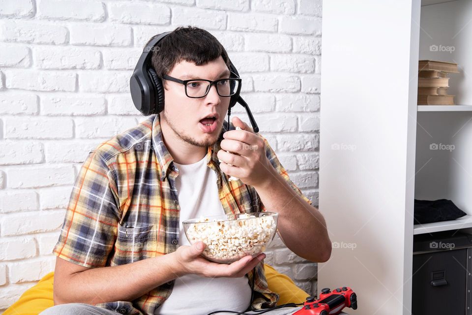 young emotional man playing video games