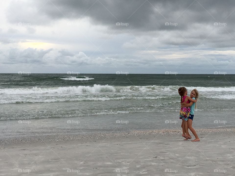 Two sisters playing at beach