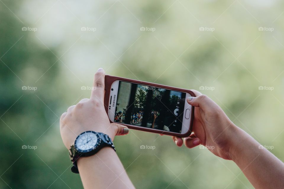 Two hands taking a photo on a smartphone