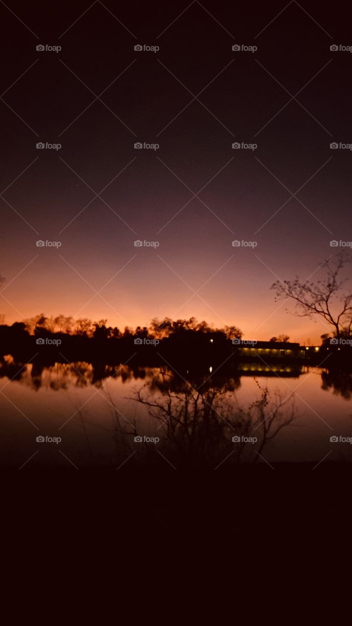 Reflections, mirrored image of Lake in beautiful colors. Above the night sky is moving in very close. 