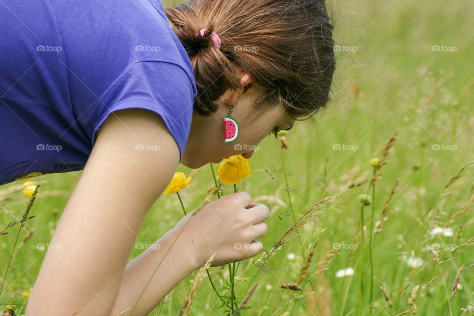 Girl smelling a flower