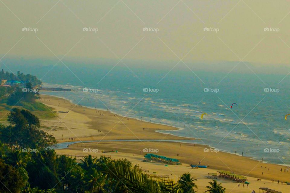 India Goa The aerial view of the beach, where sea and sky meet with an endless point. Everything else looks small in front of nature. 