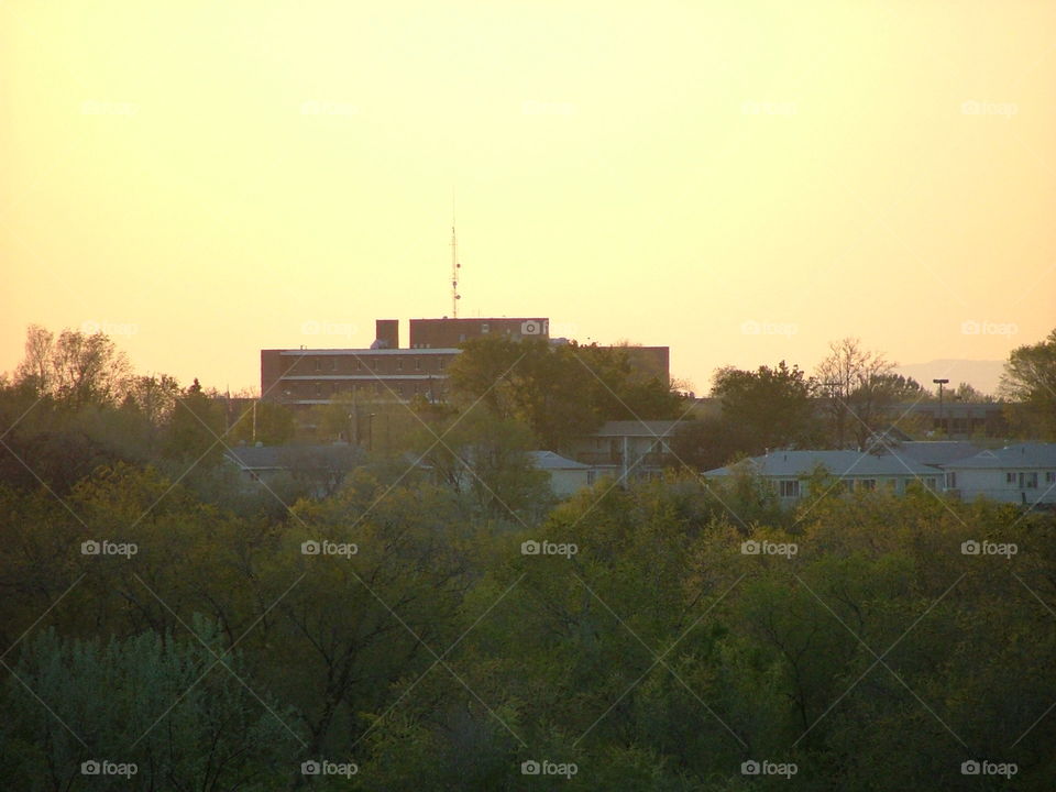 On the horizon.. An old hospital presents itself through the glow of a setting sun.