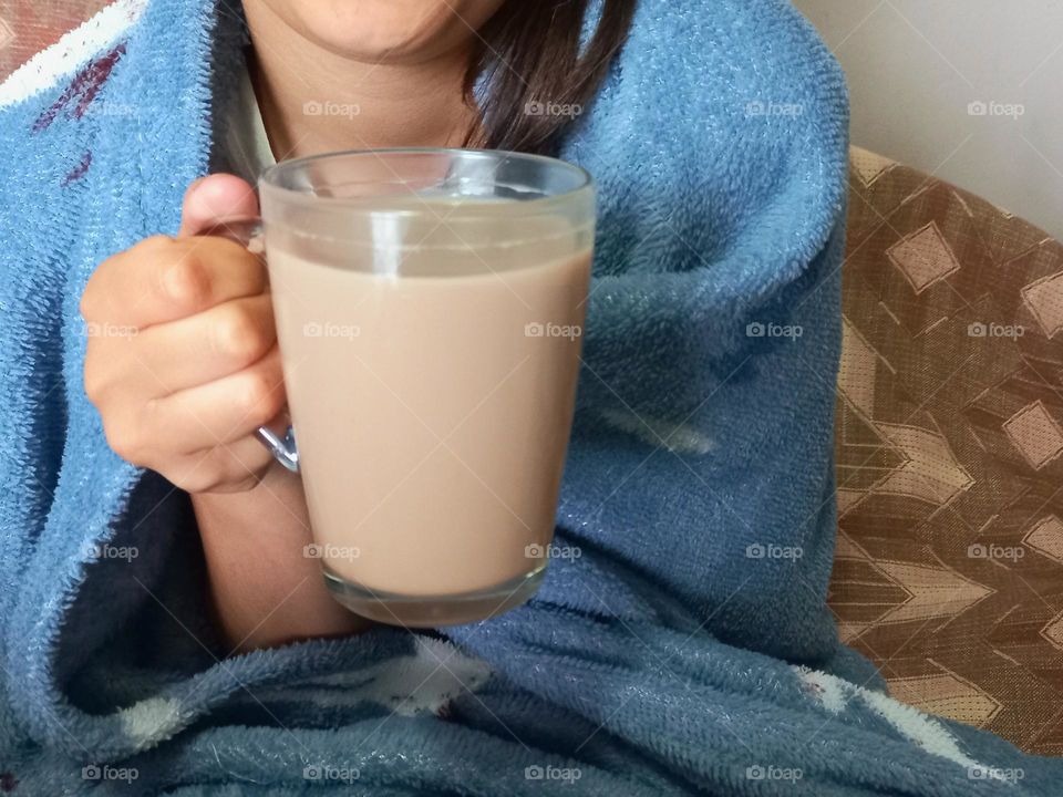 girl holding a glass of cocoa